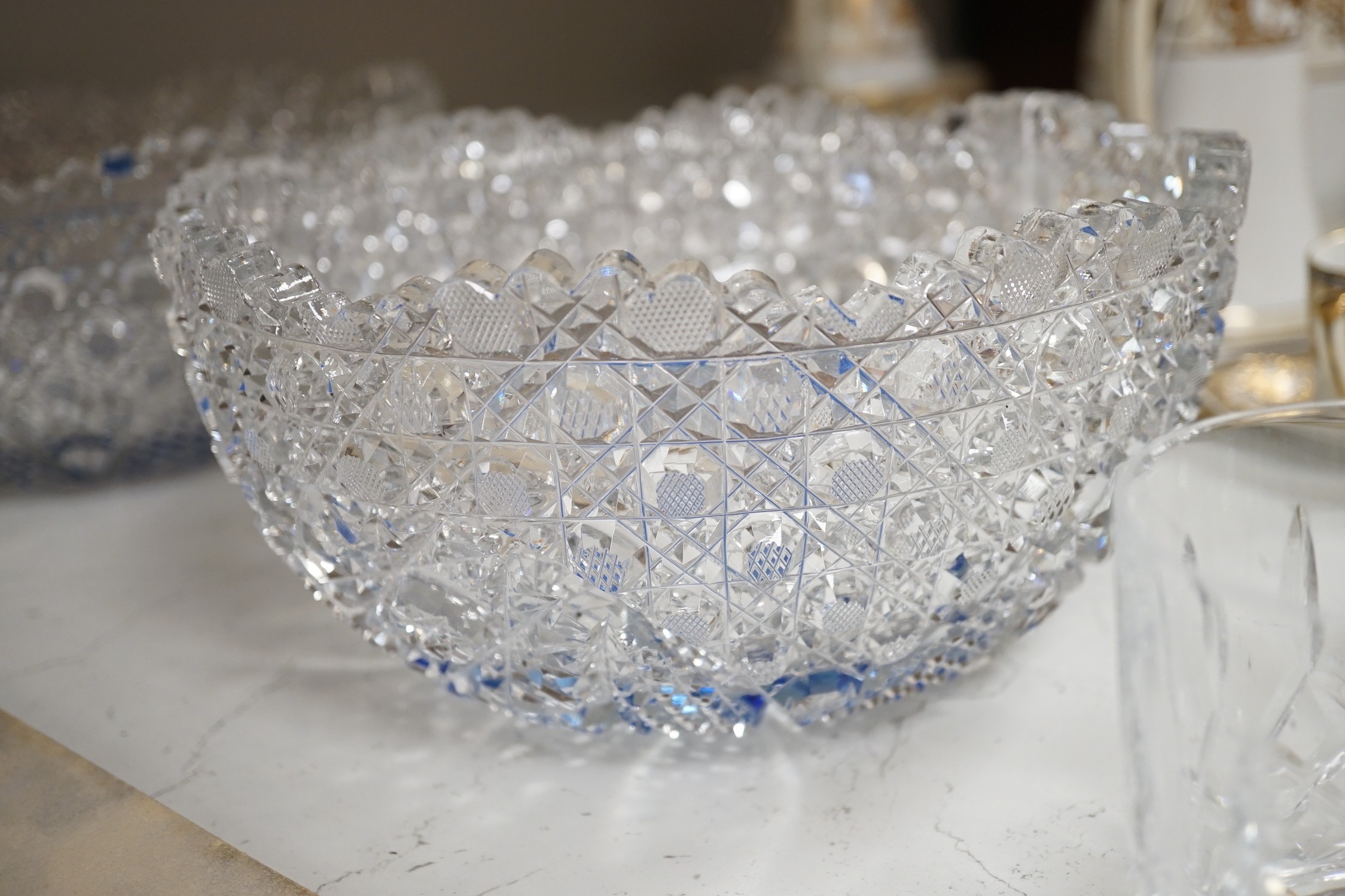 A Pair of Bohemian or Czech heavy cuts glass fruit bowls with blue flashed centres, 22.5 cm diameter, two decanters and six tumblers.